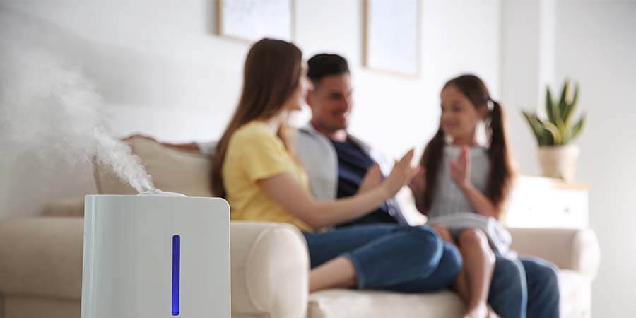 mom, dad, daughter in home with humidifier