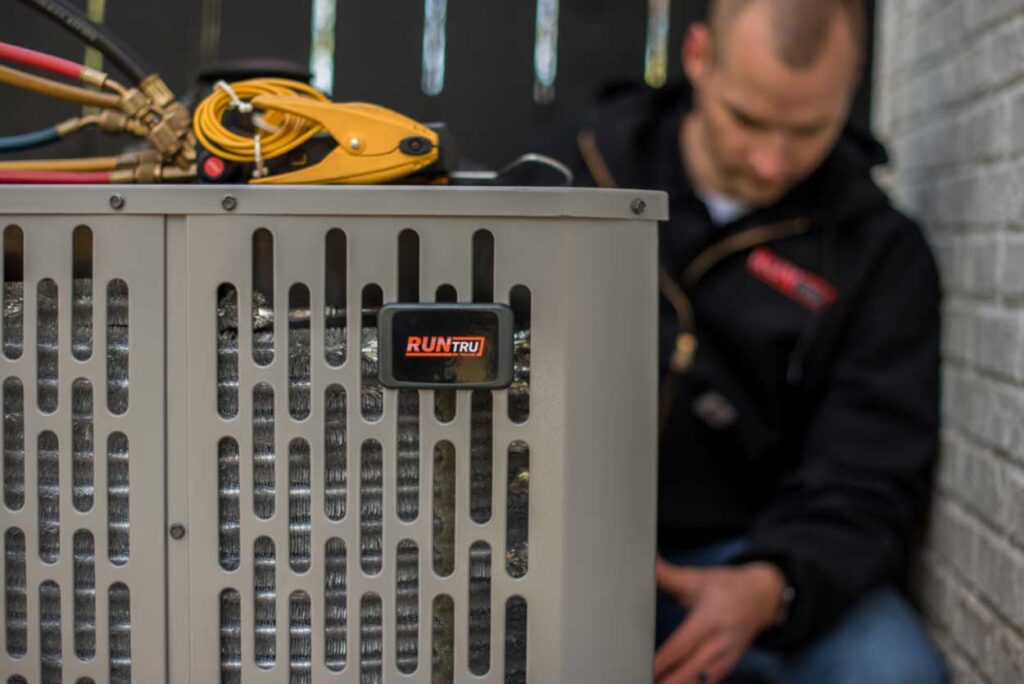 trane tech performing maintenance on unit